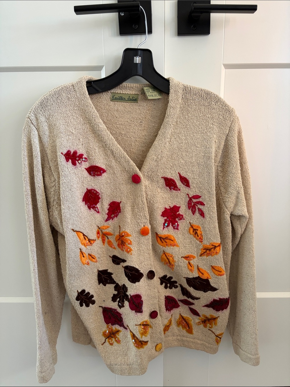 Beige V‑Neck Sweater with Red and Orange Leaf Accents
